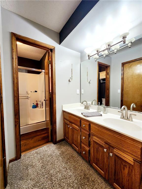 bathroom with walk in shower and vanity