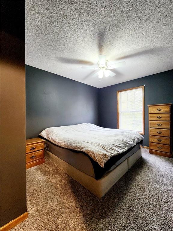 bedroom with carpet, a textured ceiling, and ceiling fan