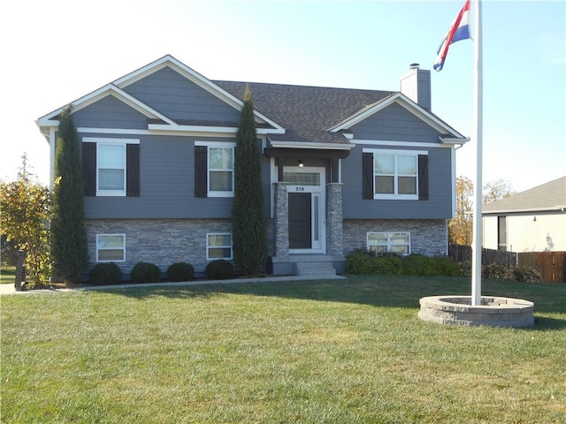 bi-level home with a front lawn