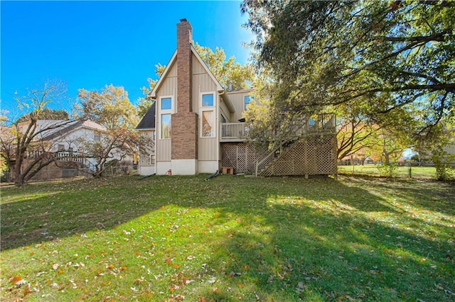 rear view of house with a yard and a deck