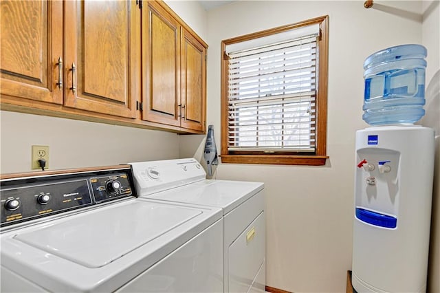 washroom with cabinets and independent washer and dryer