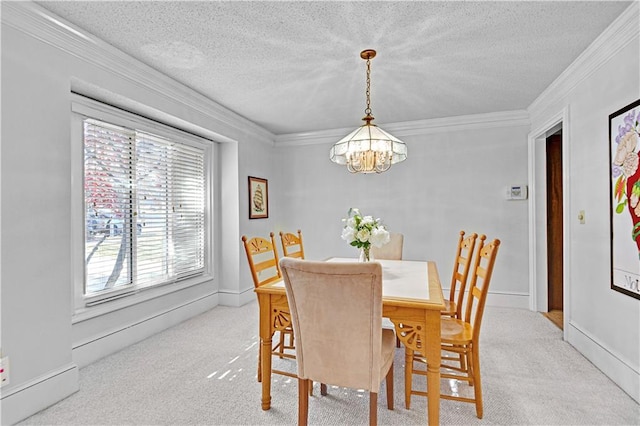 dining space with ornamental molding, a textured ceiling, and an inviting chandelier