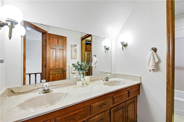 bathroom with vanity, vaulted ceiling, and shower with separate bathtub