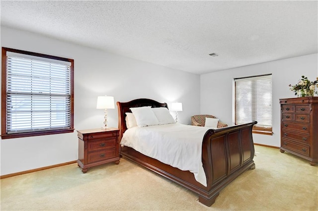 carpeted bedroom featuring a textured ceiling