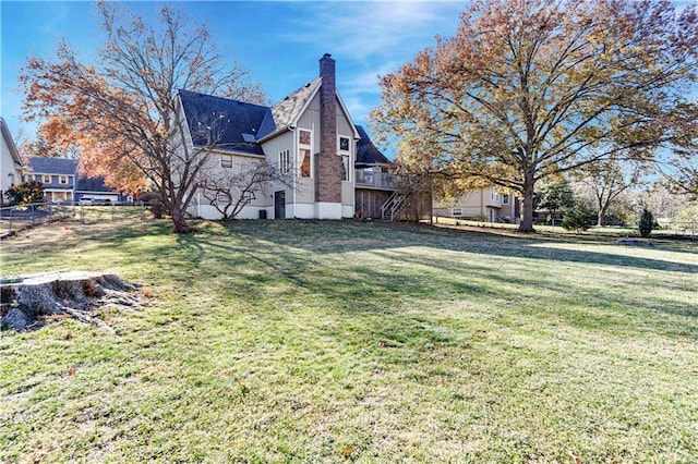 view of side of property with a yard