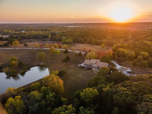 aerial view at dusk with a water view