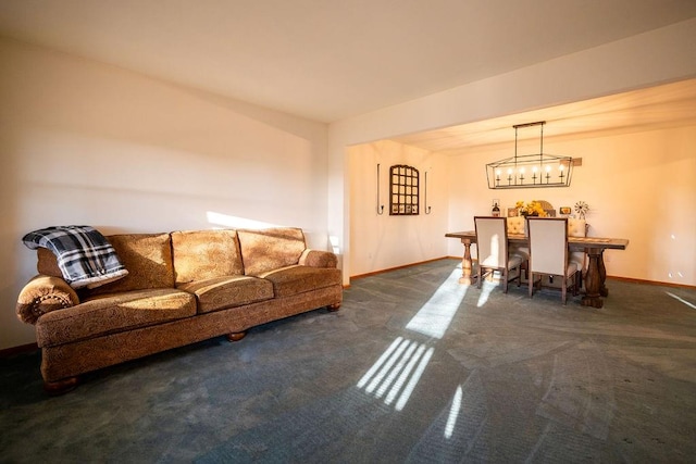 carpeted living room with a chandelier