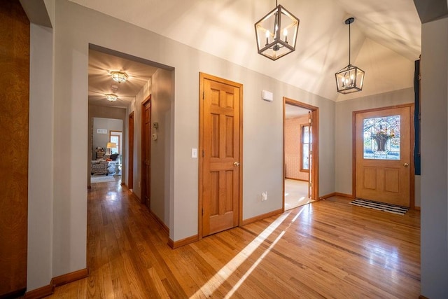 foyer entrance featuring hardwood / wood-style flooring and vaulted ceiling