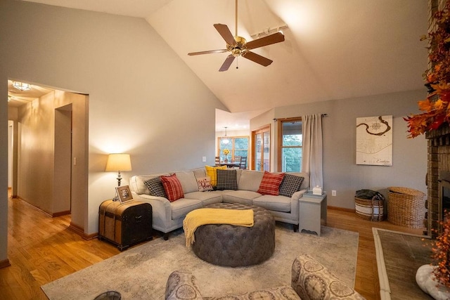 living room with high vaulted ceiling, light wood-type flooring, and ceiling fan