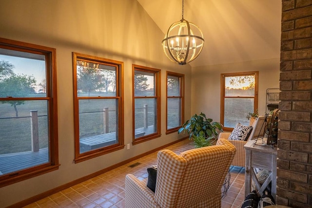 sunroom with lofted ceiling and a notable chandelier