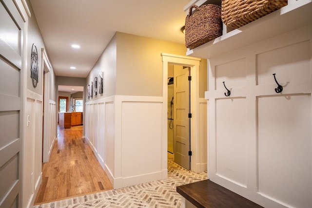 mudroom with light hardwood / wood-style floors