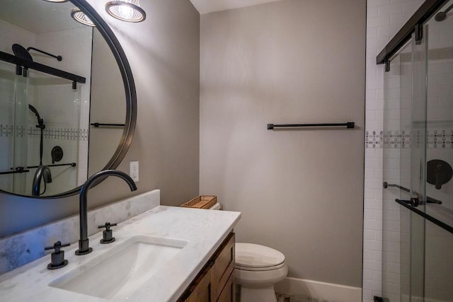 bathroom featuring vanity, toilet, and walk in shower