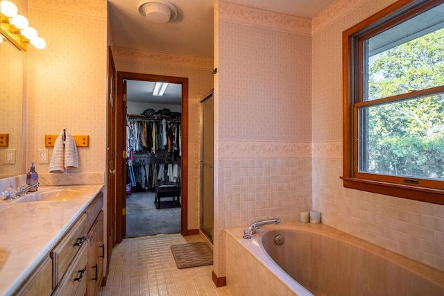 bathroom featuring vanity, independent shower and bath, and tile patterned flooring