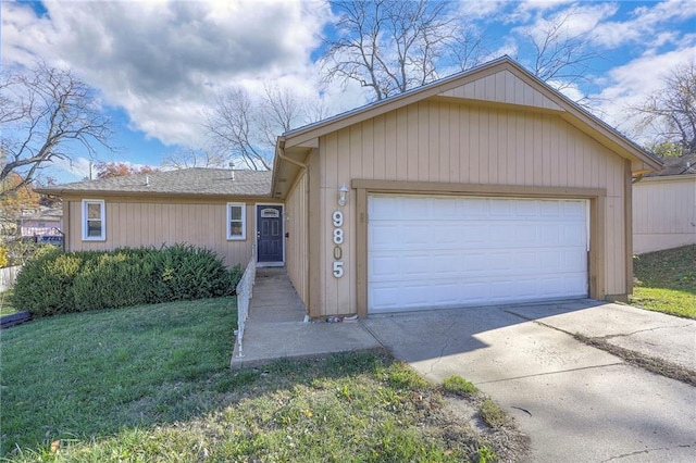 single story home with a garage and a front lawn