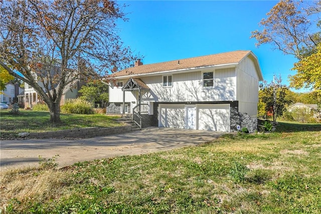 back of house with a garage and a yard