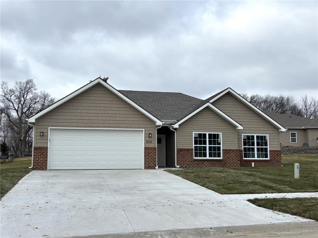 view of front of home with a front lawn and a garage