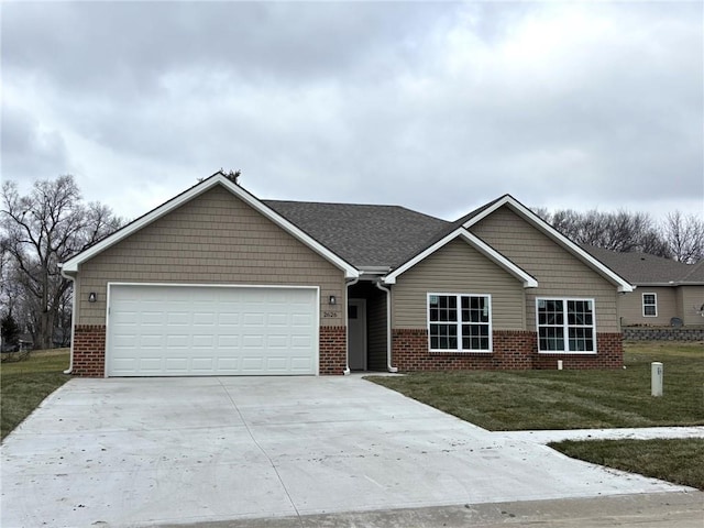 view of front of home with a front lawn and a garage