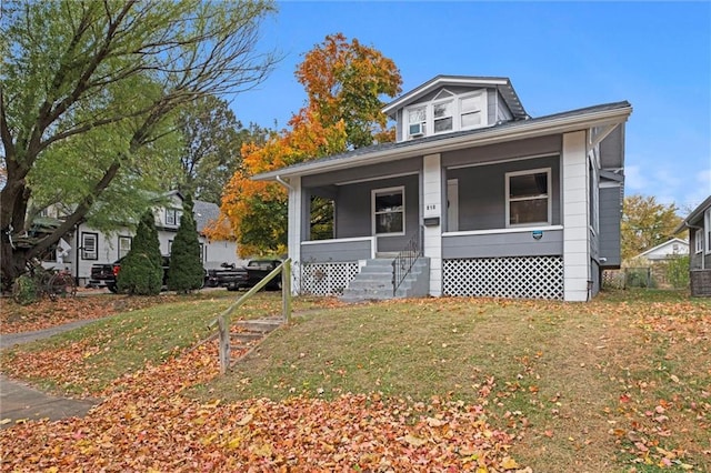 bungalow with a porch and a front yard