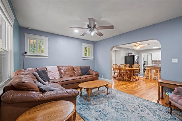 living room featuring hardwood / wood-style floors and ceiling fan