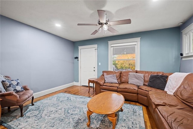 living room featuring light wood-type flooring and ceiling fan