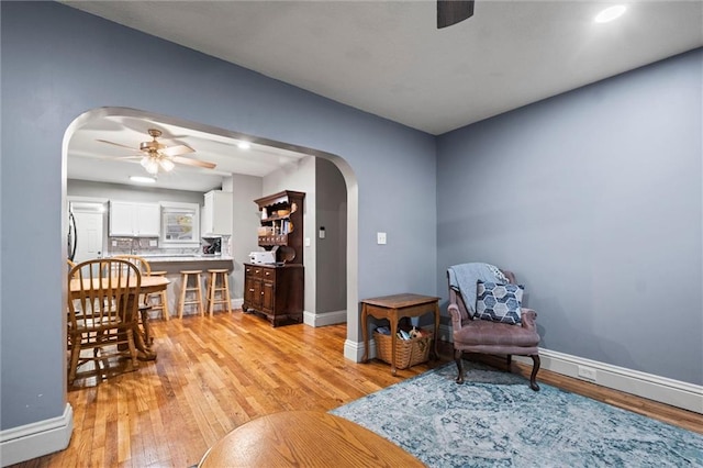 sitting room with light wood-type flooring and ceiling fan