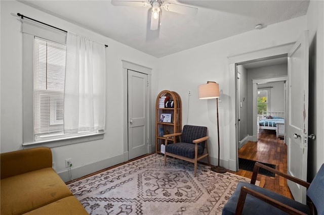 sitting room featuring hardwood / wood-style floors and ceiling fan