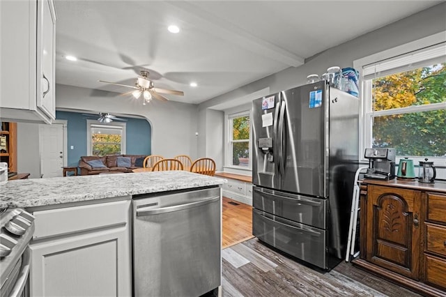 kitchen featuring white cabinets, a wealth of natural light, appliances with stainless steel finishes, and hardwood / wood-style floors