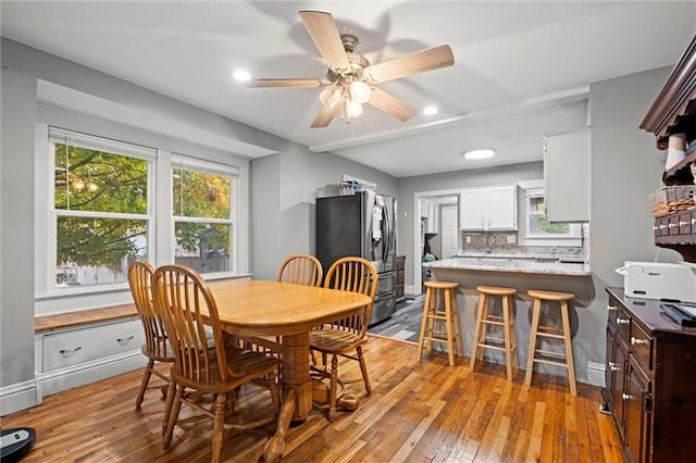 dining area featuring ceiling fan and light hardwood / wood-style flooring