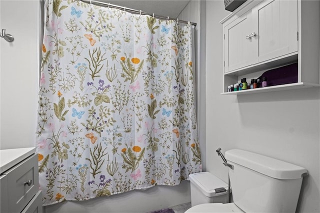 full bathroom featuring toilet, vanity, and shower / bathtub combination with curtain