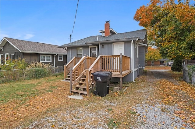 rear view of house with a wooden deck