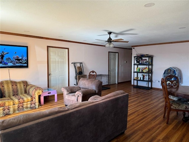 living room with ceiling fan, crown molding, and dark hardwood / wood-style floors