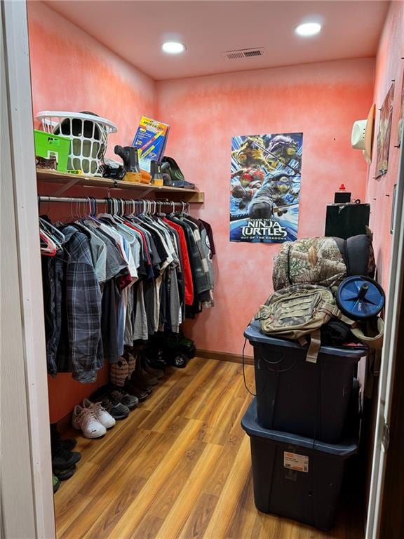 spacious closet featuring hardwood / wood-style floors