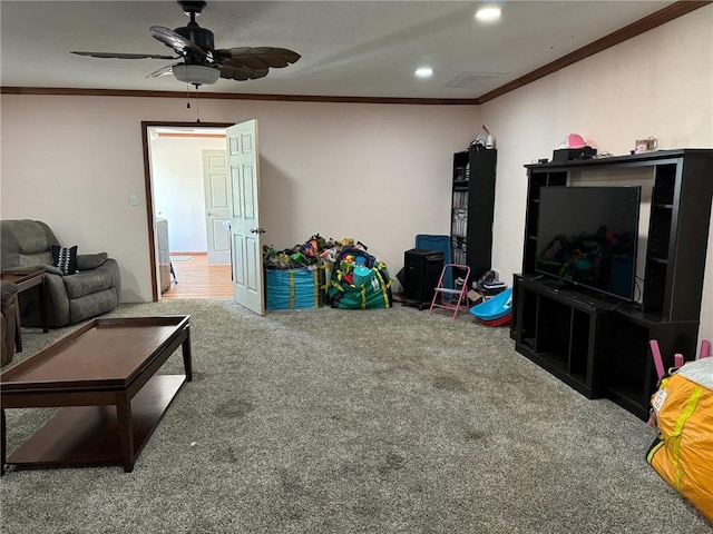 game room with carpet floors, ceiling fan, and ornamental molding