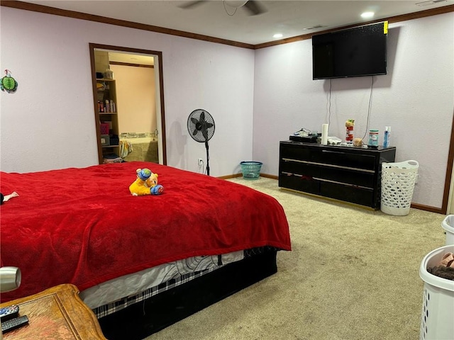 bedroom featuring carpet flooring, connected bathroom, ceiling fan, and ornamental molding