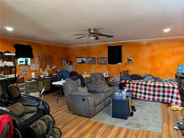 living room with ceiling fan, ornamental molding, a textured ceiling, and hardwood / wood-style flooring