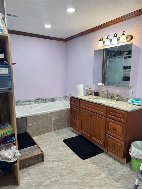 bathroom featuring vanity, tile patterned floors, ornamental molding, and independent shower and bath