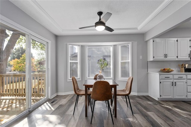 dining area with ceiling fan, a textured ceiling, and dark hardwood / wood-style flooring