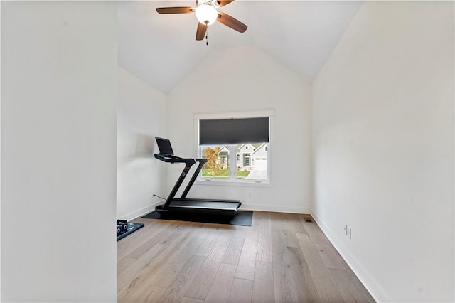 exercise area featuring light hardwood / wood-style flooring, ceiling fan, and vaulted ceiling