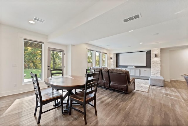 dining space featuring hardwood / wood-style flooring and a healthy amount of sunlight