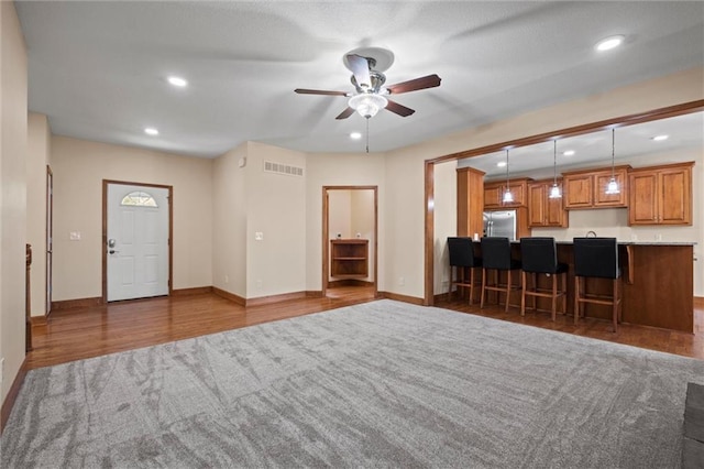 unfurnished living room featuring dark hardwood / wood-style floors and ceiling fan