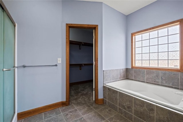 bathroom featuring a relaxing tiled tub