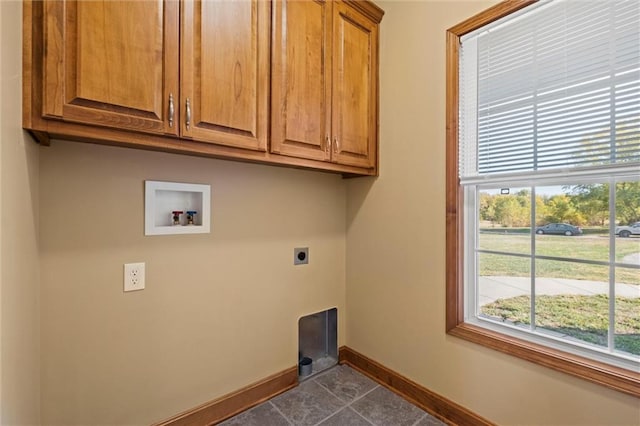 laundry room with hookup for an electric dryer, tile patterned floors, hookup for a washing machine, and cabinets