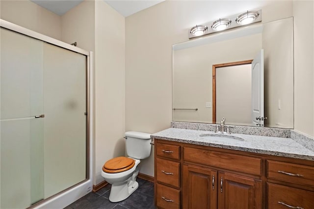 bathroom with toilet, tile patterned flooring, vanity, and a shower with door