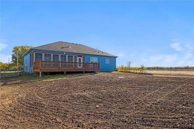 back of house featuring a wooden deck