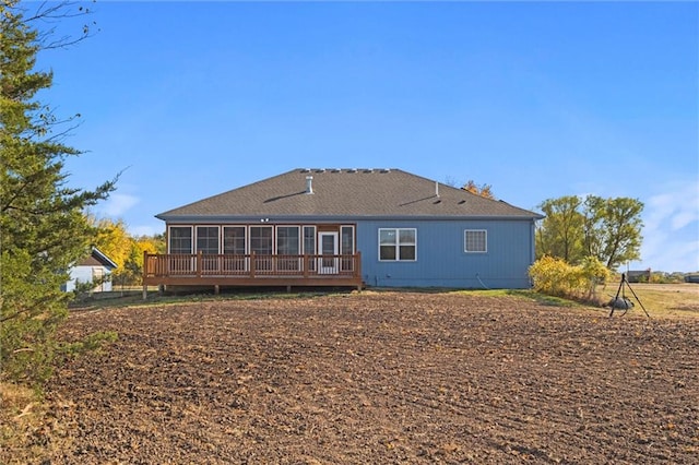 back of house featuring a wooden deck