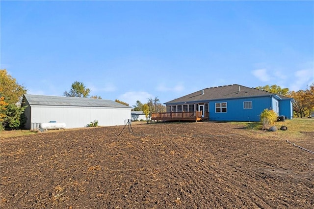 back of house featuring a wooden deck