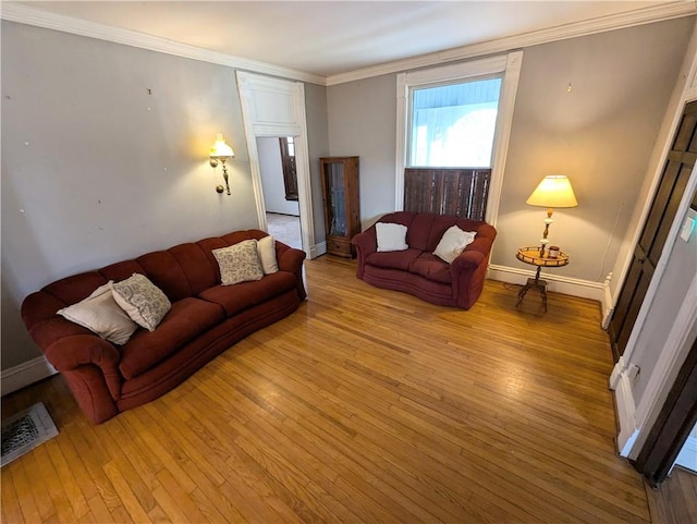 living room featuring crown molding and light wood-type flooring