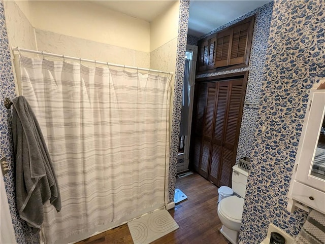 bathroom with toilet, hardwood / wood-style flooring, and a shower with shower curtain