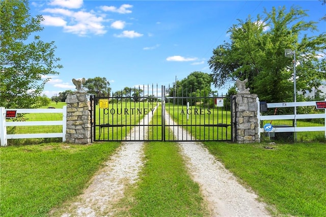 view of gate featuring a yard