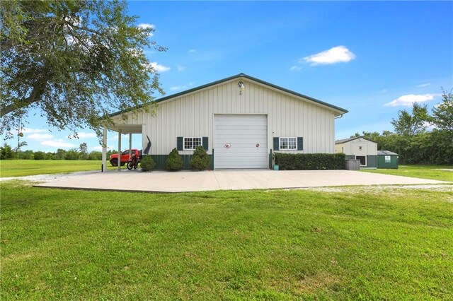 garage featuring a yard and central AC unit